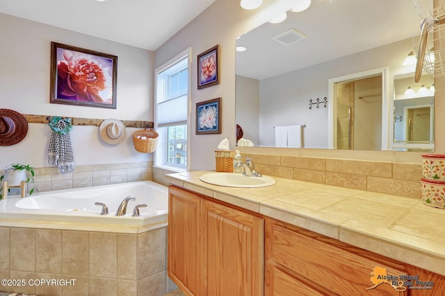 full bath with a bath and vanity