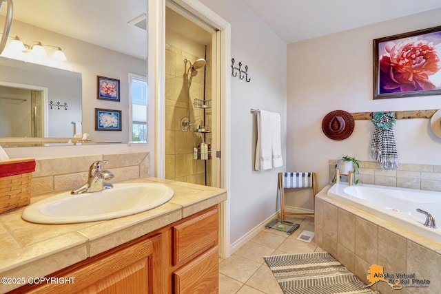 bathroom featuring tile patterned floors, tiled bath, baseboards, vanity, and tiled shower