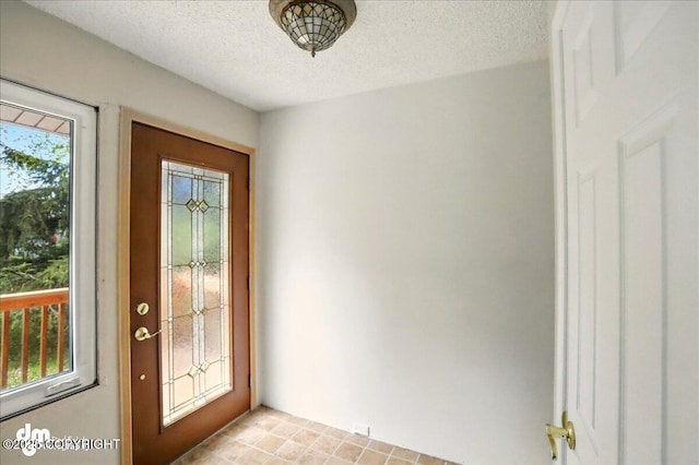 entryway featuring a textured ceiling