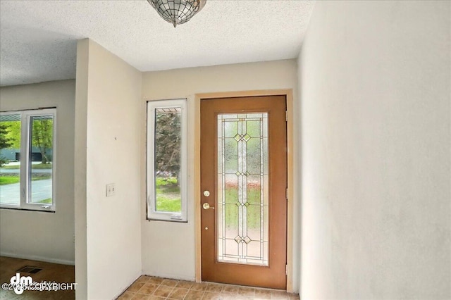 entryway featuring a textured ceiling