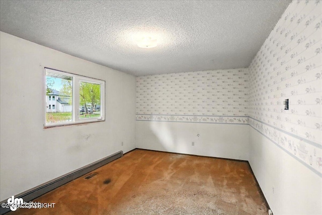 unfurnished room featuring wallpapered walls, a textured ceiling, baseboard heating, and carpet floors