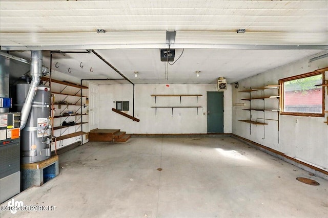 garage with strapped water heater and a garage door opener