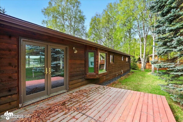wooden terrace featuring french doors and a yard