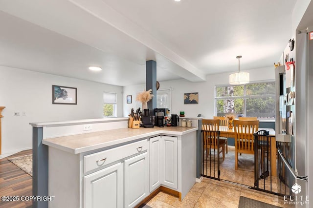 kitchen with light countertops, white cabinets, decorative light fixtures, recessed lighting, and high quality fridge