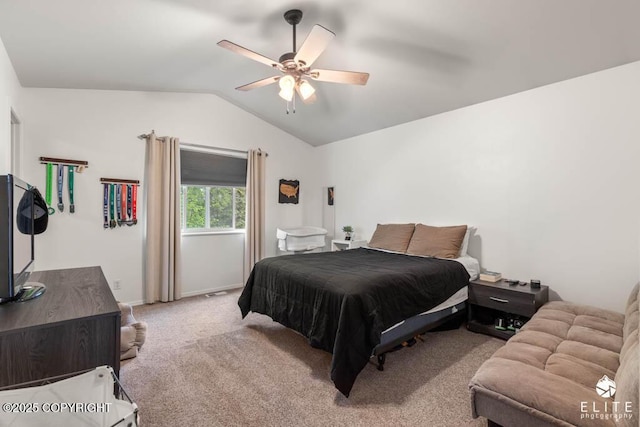 bedroom featuring vaulted ceiling, light carpet, and ceiling fan