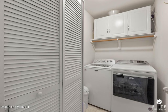 laundry area featuring washing machine and dryer and cabinet space
