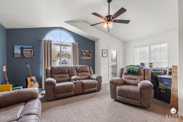 carpeted living area with a ceiling fan, lofted ceiling, and baseboards