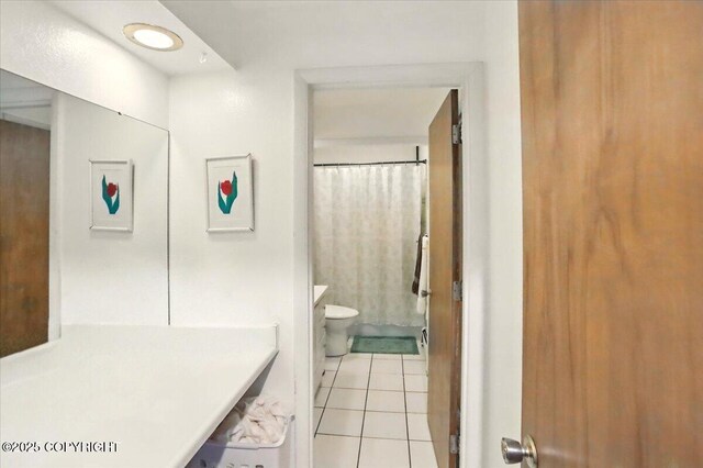 bathroom with toilet, tile patterned flooring, a shower with shower curtain, and vanity