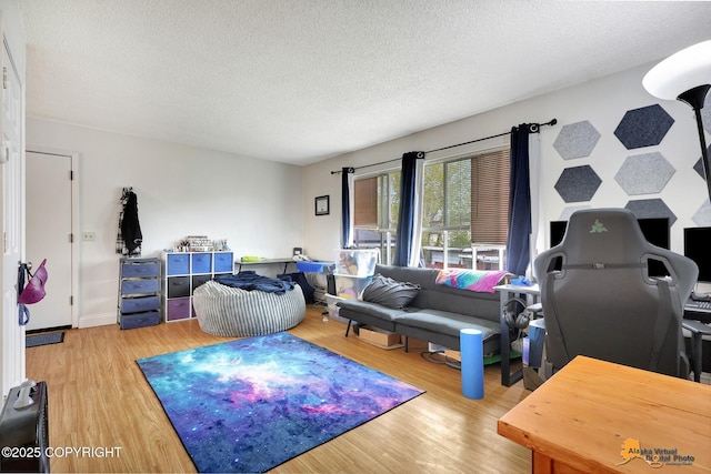 living area with a textured ceiling and wood finished floors