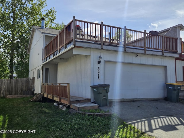 3213 Tayshee Cir, Anchorage, AK 99504 - rear view of house with driveway and a balcony