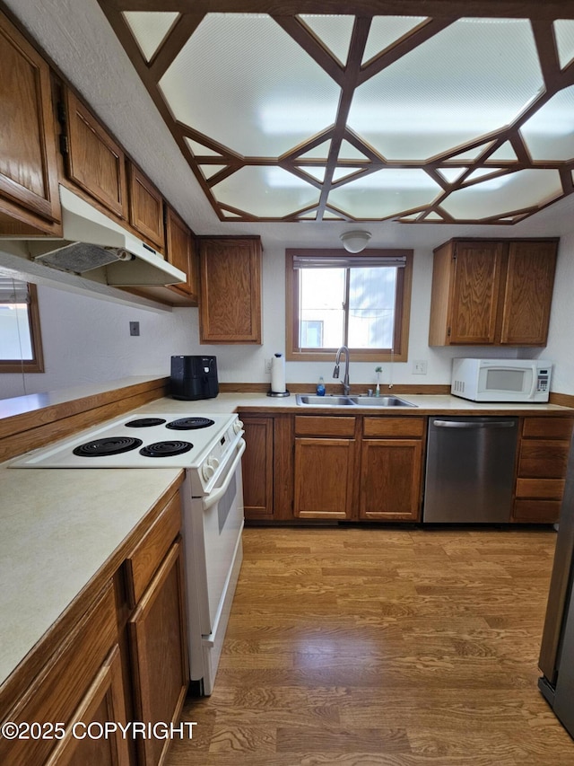 3213 Tayshee Cir, Anchorage, AK 99504 - kitchen featuring white appliances, a sink, light wood-style floors, light countertops, and brown cabinetry