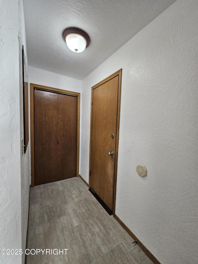 3213 Tayshee Cir, Anchorage, AK 99504 - hall featuring a textured wall and baseboards