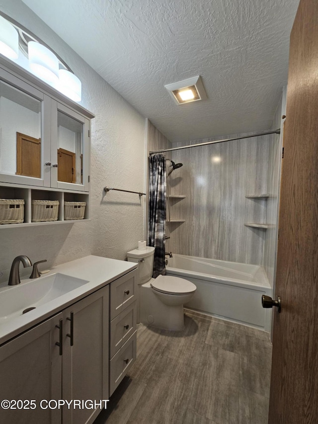 3213 Tayshee Cir, Anchorage, AK 99504 - full bath with wood finished floors, a textured wall, vanity, a textured ceiling, and shower / tub combo