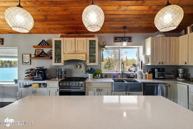 kitchen featuring high end range, dishwasher, a sink, light countertops, and wooden ceiling