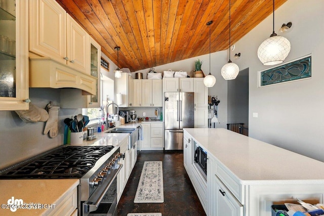 kitchen featuring premium appliances, wooden ceiling, lofted ceiling, a kitchen island, and light countertops