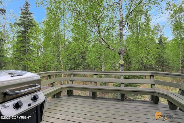 wooden deck featuring a grill