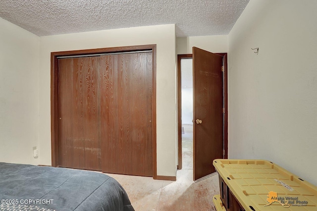 bedroom with a closet and a textured ceiling