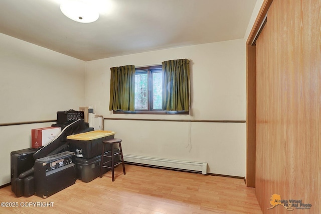 interior space featuring a baseboard radiator and wood finished floors