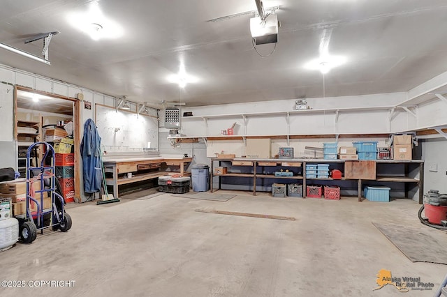 garage with a workshop area and a garage door opener