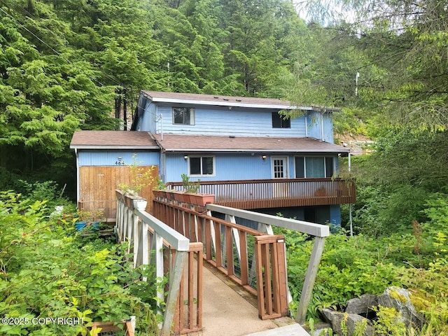 464 Schoenbar Rd, Ketchikan, AK 99901 - rear view of property with a wooded view, a deck, and roof with shingles