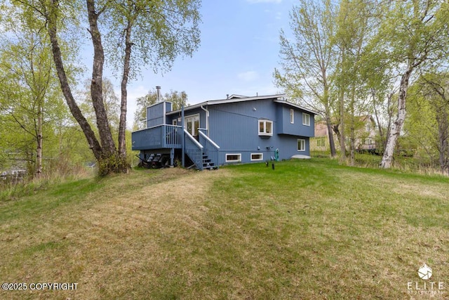 back of property with a deck, a yard, a chimney, and stairs