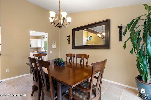 dining space with a chandelier, baseboards, and light tile patterned flooring