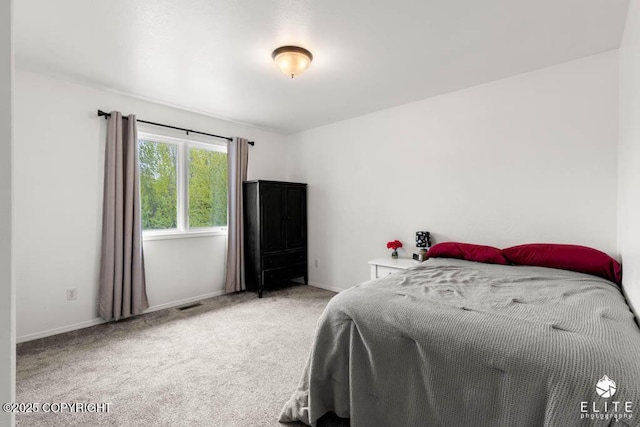 carpeted bedroom with baseboards