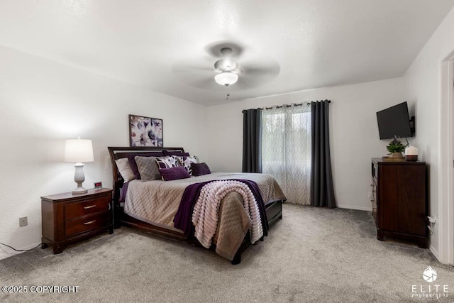 bedroom featuring light colored carpet and a ceiling fan