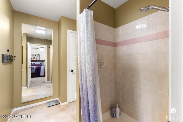 full bathroom with a tile shower, connected bathroom, and tile patterned flooring