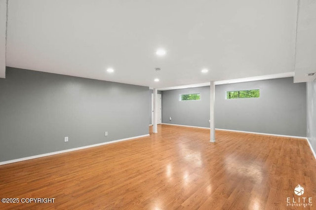 basement with recessed lighting, baseboards, and light wood-type flooring