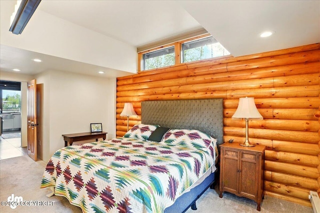 bedroom featuring light carpet, recessed lighting, and a baseboard heating unit