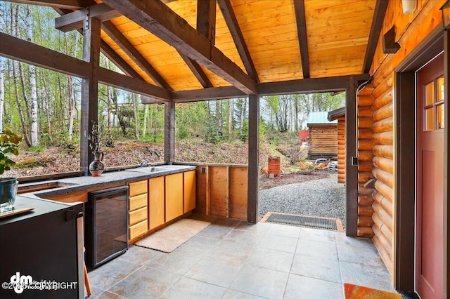 unfurnished sunroom featuring plenty of natural light and wine cooler