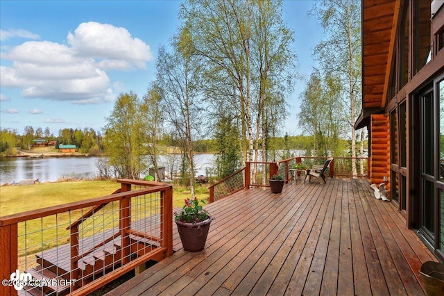 wooden deck with a water view and a yard