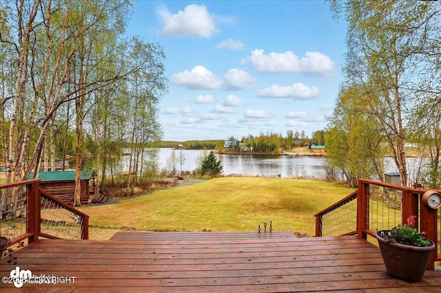 wooden deck featuring a water view and a yard