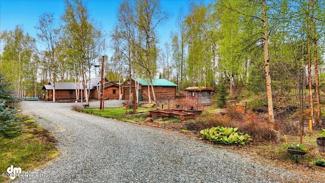 view of front of property featuring gravel driveway and metal roof