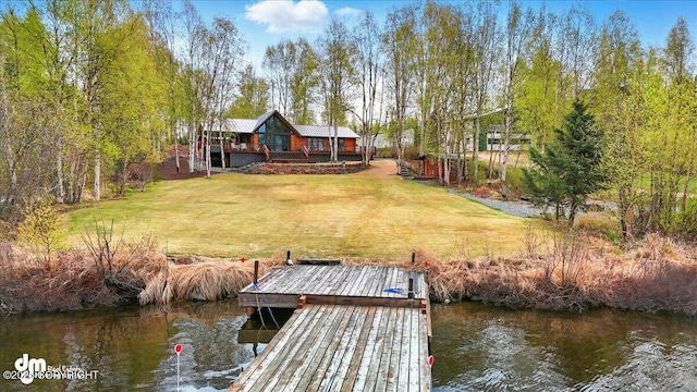 dock area with a water view and a yard