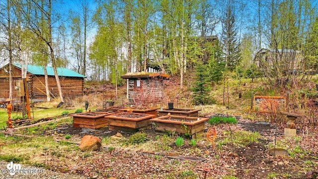 view of yard featuring a garden and an outbuilding