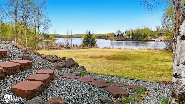 view of grassy yard with a water view