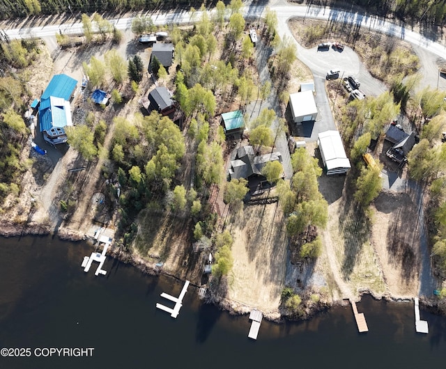 aerial view of property and surrounding area featuring a large body of water