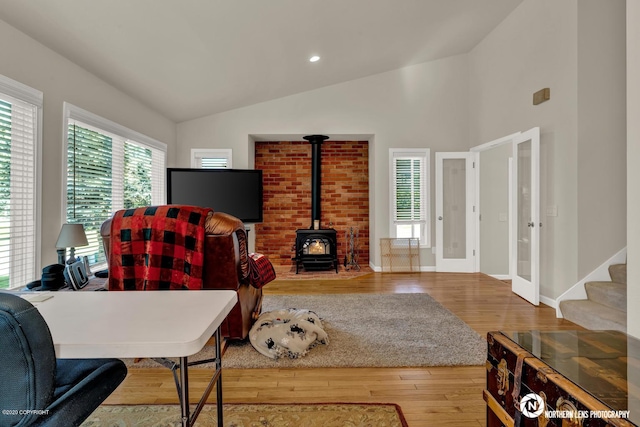 19426 Pribilof Loop, Eagle River, AK 99577 - living room with lofted ceiling, a wood stove, wood finished floors, french doors, and baseboards