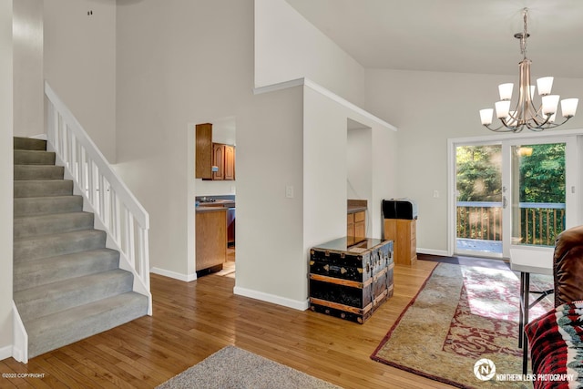 19426 Pribilof Loop, Eagle River, AK 99577 - living area featuring light wood-type flooring, a chandelier, baseboards, and high vaulted ceiling