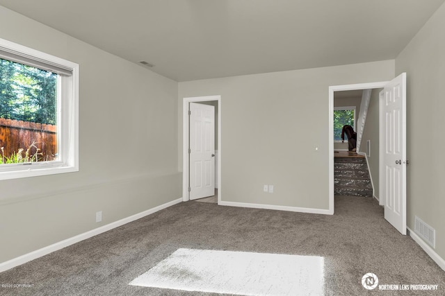 19426 Pribilof Loop, Eagle River, AK 99577 - unfurnished bedroom with multiple windows, carpet, and baseboards