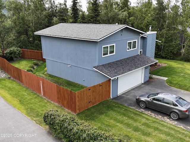 19426 Pribilof Loop, Eagle River, AK 99577 - view of front of home featuring roof with shingles, driveway, a chimney, and a garage
