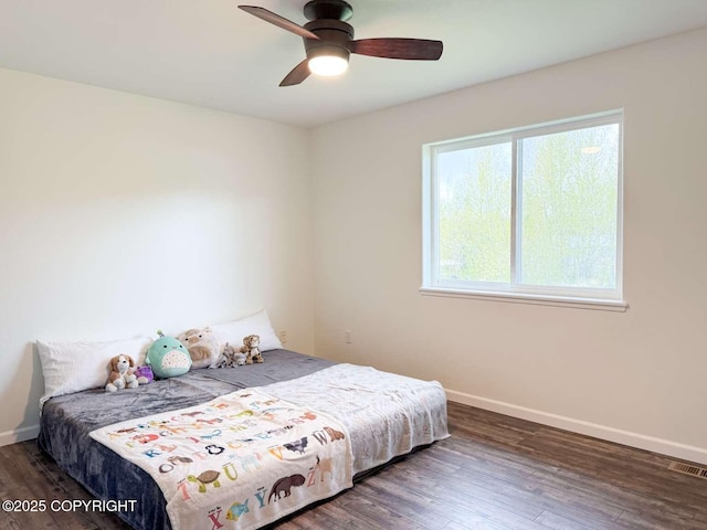 bedroom with wood finished floors, baseboards, and a ceiling fan