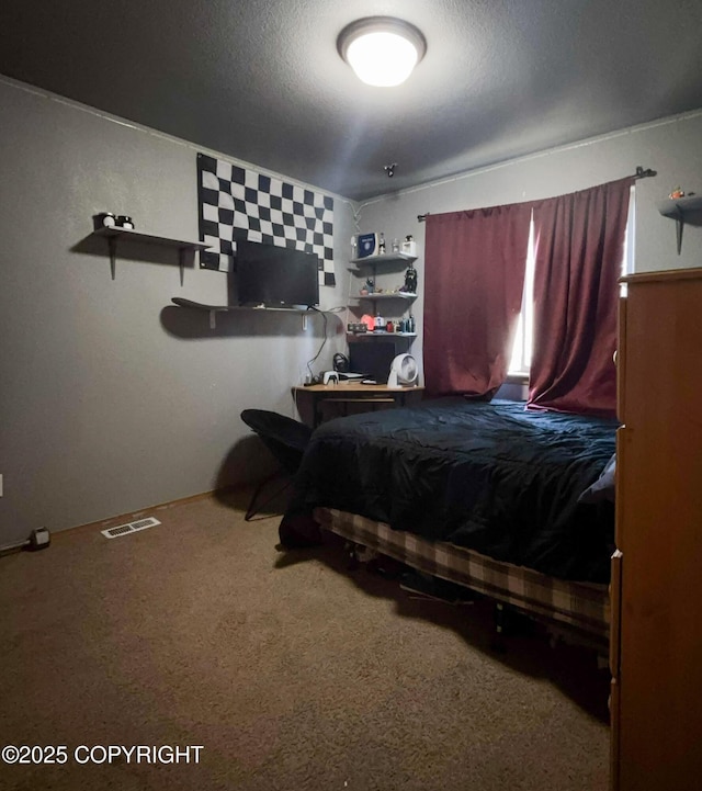 carpeted bedroom with a textured ceiling