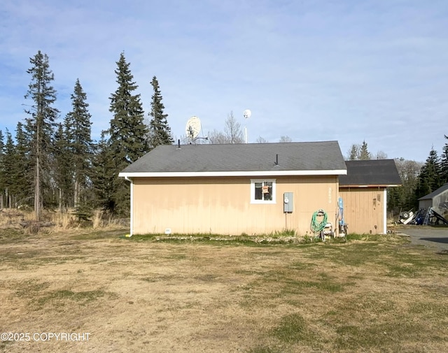 rear view of property with a yard