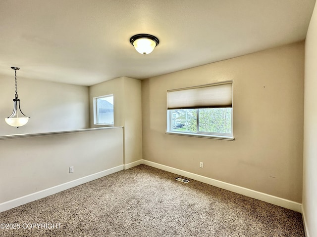 5612 Grand Teton Loop, Anchorage, AK 99502 - carpeted spare room featuring plenty of natural light and baseboards