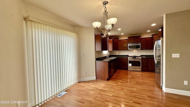 5612 Grand Teton Loop, Anchorage, AK 99502 - kitchen with stainless steel appliances, baseboards, light wood-style floors, a sink, and recessed lighting