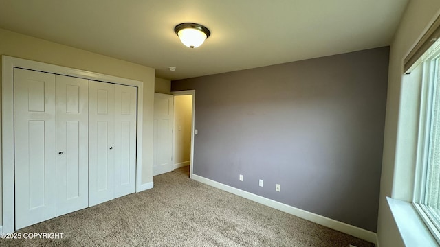 5612 Grand Teton Loop, Anchorage, AK 99502 - unfurnished bedroom featuring carpet floors, baseboards, and a closet