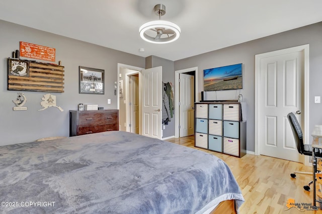 bedroom featuring wood finished floors and baseboards